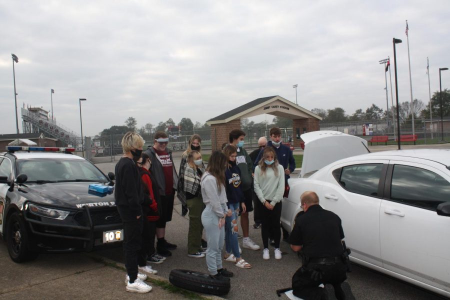 Officer Kryzs Teaches Students How To Change A Tire