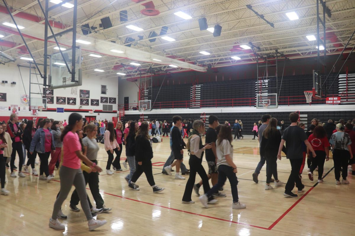 Students walk around the gym at the Breast Cancer Awareness walk. 