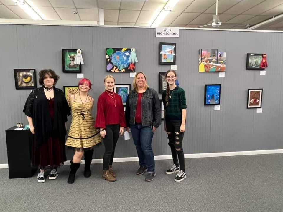 Johnston poses with four of her students standing in front of their art entries. Photo used with permission of Betty Smith-Montgomery.