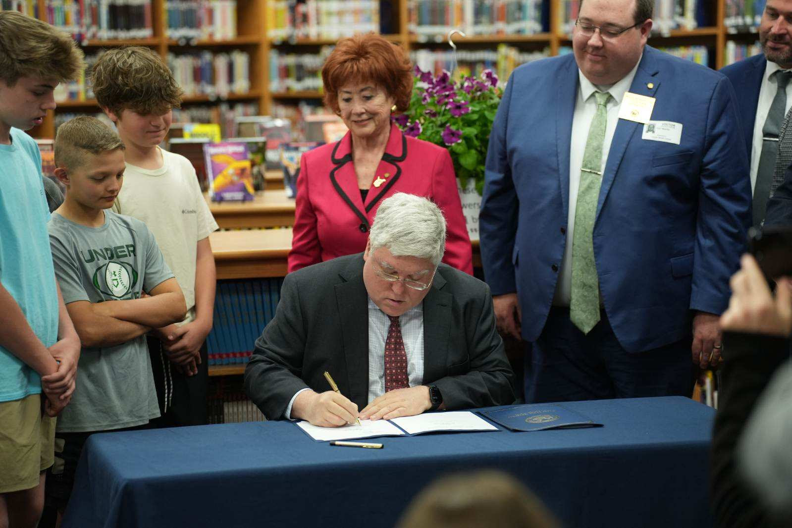 Patrick Morrisey signs House Bill 2003 and Senate Bill 280. Students of Lincoln Middle School as well as Del. Mickey Petitto, R-Harrison and Carl Martin, R-Upsher watch. (West Virginia Office of the Gov. Patrick Morrisey | Courtesy photo) 